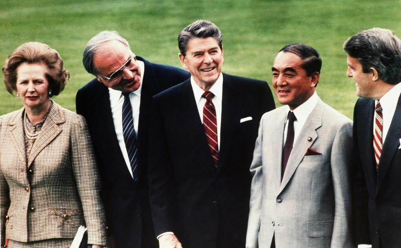 In this May 3, 1985, file photo, then Japan's Prime Minister Yasuhiro Nakasone, second right, then British Prime Minister Margaret Thatcher, left, then West German Chancellor Helmut Kohl, second left, then U.S. President Ronald Reagan, center, and then Canada's Prime Minister Brian Mulroney at the World Economic Summit in the garden of Palais Schaumburg in Bonn. 