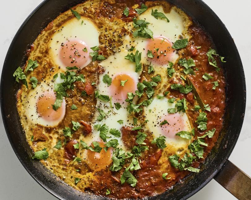 A skillet of eggs in a tomato sauce. This heady, aromatic meal goes well alongside toast or nestled on a bed of rice. Food styled by Rebecca Jurkevich. (Johnny Miller/The New York Times)