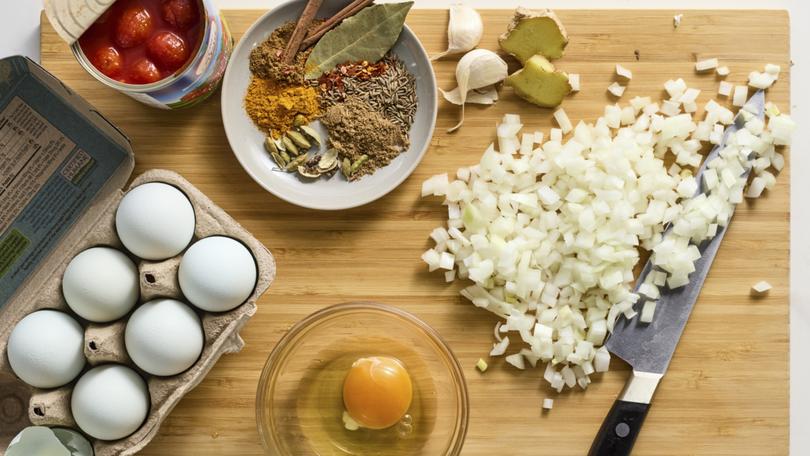 Ingredients for skillet eggs with garam masala and tomatoes. This heady, aromatic meal goes well alongside toast or nestled on a bed of rice. Food styled by Rebecca Jurkevich. 