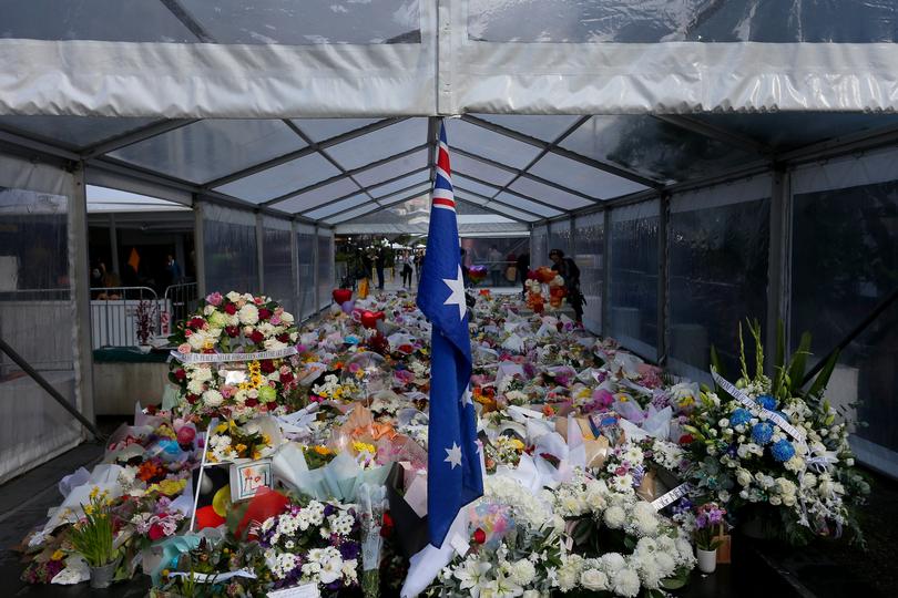 Flower tributes are seen at the edge of Westfield Bondi Junction during a day of reflection on April 18, 2024 in Bondi Junction, Australia.