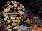 Flower tributes and condolence messages are seen at the edge of Westfield Bondi Junction during a day of reflection on April 18, 2024, in Bondi Junction, Australia. 