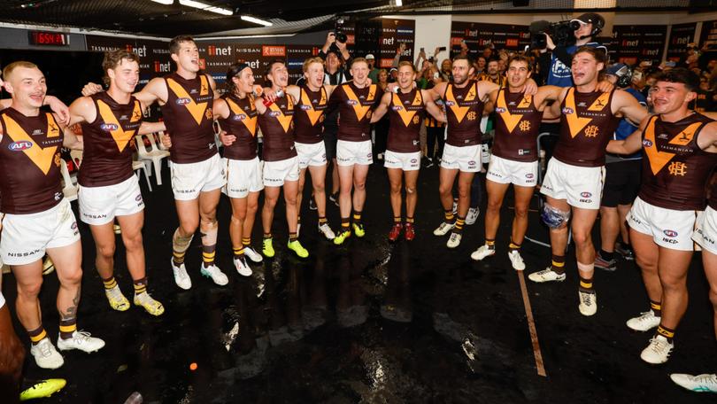The Hawks sing the team song after beating North Melbourne.