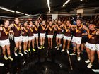 The Hawks sing the team song after beating North Melbourne.
