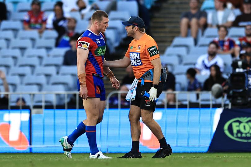 A Knights training attempts to calm Jack Hetherington as he walks off the field - it didn’t work.