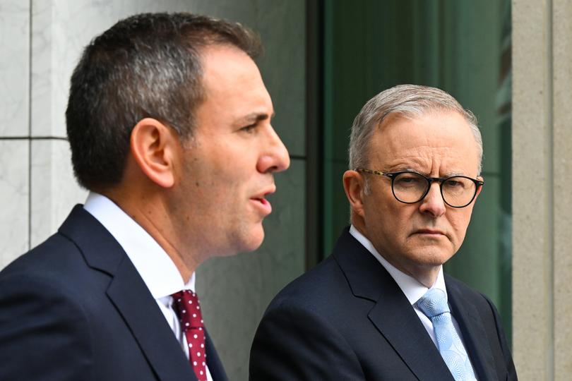 Australian Prime Minister Anthony Albanese listens to Australian Treasurer Jim Chalmers speak to the media during a press conference tat Parliament House in Canberra, Tuesday, February 28, 2023. (AAP Image/Lukas Coch) NO ARCHIVING