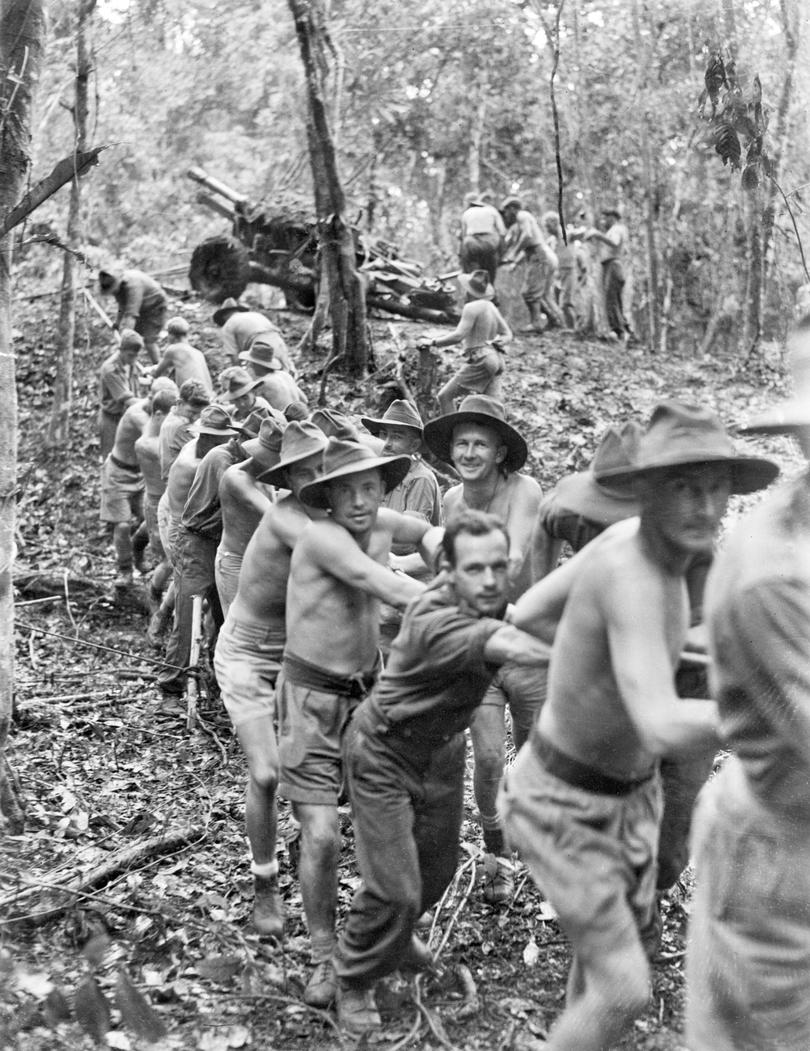 ID number    026855
Photographer    Fisher, Thomas
Object type    Black & white
Place made    New Guinea: Papua New Guinea, Papua
Date made    September 1942
Physical description    Black & white
Collection    Photograph
Description
    25-Pounder guns of B Troop, 14th Field Regiment, Royal Australian Artillery, being pulled through dense jungle in the vicinity of Uberi on the Kokoda Trail, Papua and New Guinea. Members of the regiment are being assisted by the 2/1st Australian Pioneer Battalion. Identified are; fifth from right, N58727 Staff Sergeant James Edward (Jim) Nugent, (first fully visible face on right side of rope wearing hat and smiling); second on the left of the rope, (fully body visible wearing shorts, hat and belt) NX141419 Corporal Douglas Alfred Wray; fourth on the left wearing a hat, shorts and belt NX20046 Sapper Ernie Chester Walker.

