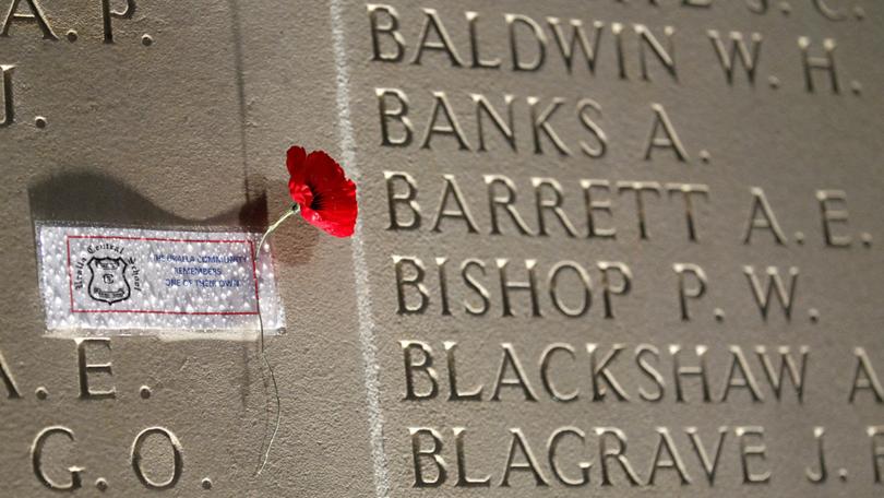 VILLERS-BRETONNEUX - APRIL 25: A poppy is displayed on a wall bearing the WWI dead soldiers' names, as he attends a dawn service at the Australian War Memorial on April 25, 2015 in Villers-Bretonneux, France. The day marks the April 25, 1915 landing of the Australian and New Zealand Army Corps (ANZAC) at Gallipoli in modern-day Turkey and has become a defining symbol of courage and comradeship for Australia and New Zealand. (Photo by Thierry Chesnot/Getty Images) Thierry Chesnot