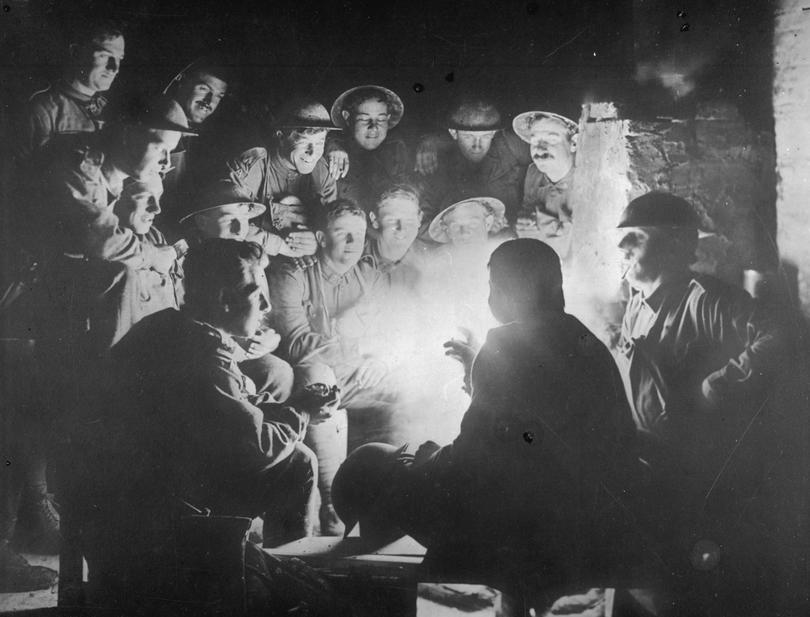 Young diggers around a brazier. Gunner Edward Whitfield of the 53rd Battery is telling a story to the group, who were about 15 years of age.
