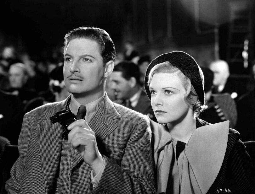 RICHARD HANNAY (ROBERT DONAT) , HOLDING A PAIR OF OPERA GLASSES, AND PAMELA (MADELAINE CARROLL) AT THE LONDON PALLADIUM TOGETHER AS THEY WATCH THE MEMORY MAN.