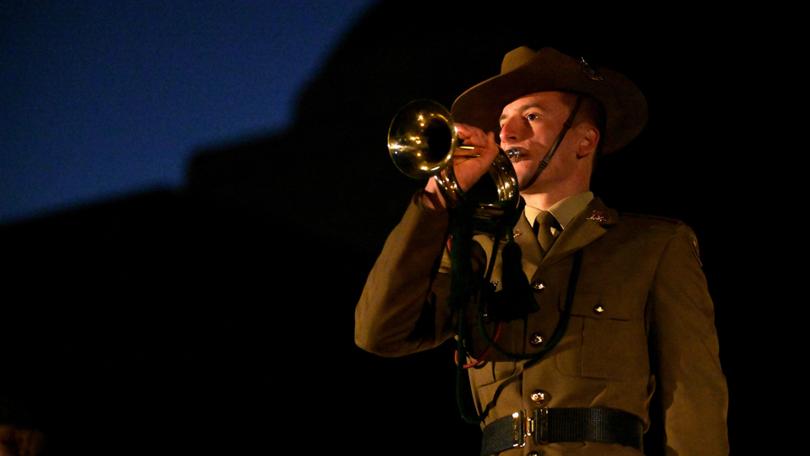 People take part in a Dawn Service for Anzac Day held at the Australian War Memorial.