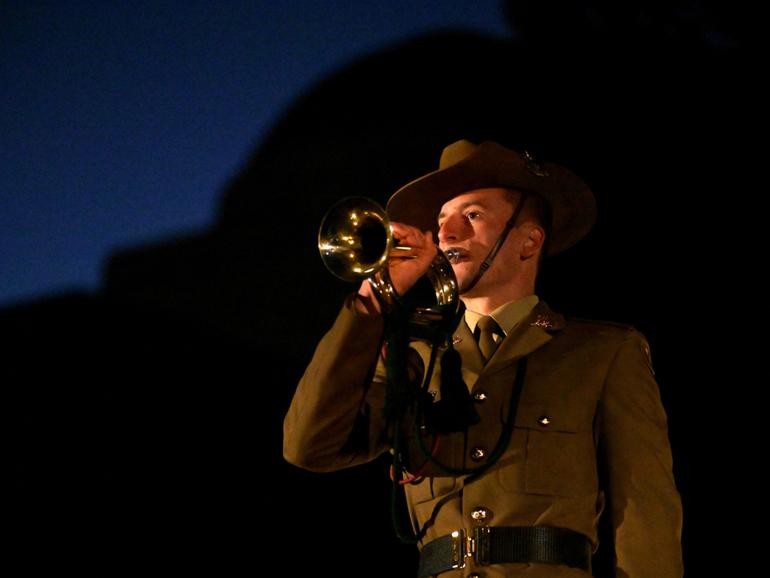 People take part in a Dawn Service for Anzac Day held at the Australian War Memorial.