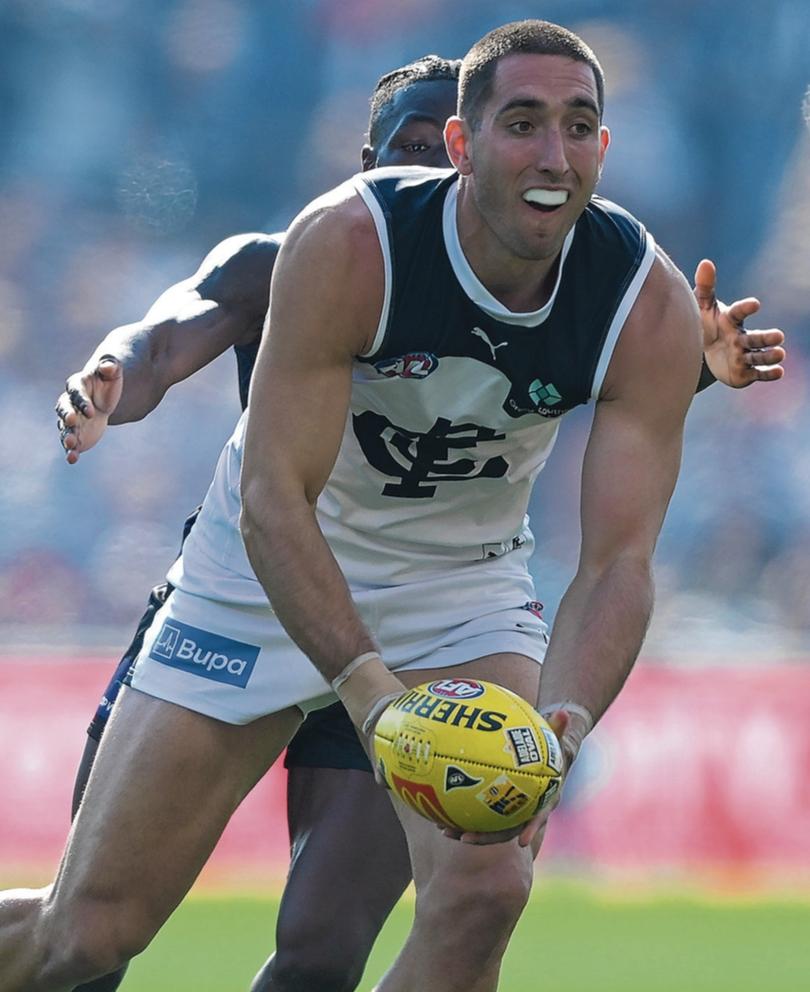 ADELAIDE, AUSTRALIA - APRIL 06: Jacob Weitering of the Blues
handballs under pressure from Michael Frederick of the Dockers during the round four AFL match between Fremantle Dockers and Carlton Blues at Adelaide Oval, on April 06, 2024, in Adelaide, Australia. (Photo by Mark Brake/Getty Images via AFL Photos)