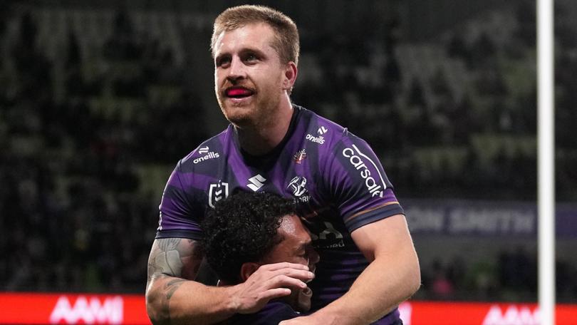 Xavier Coates celebrates with Cameron Munster after scoring his second try.