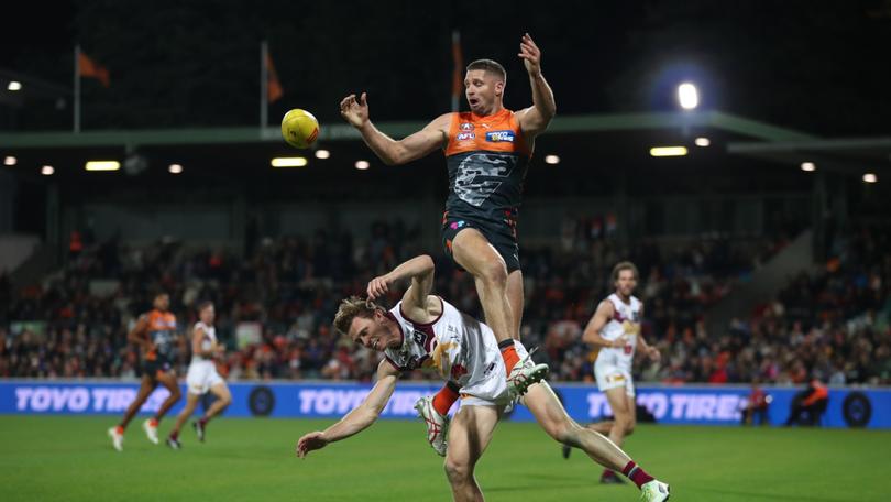 Jesse Hogan of the Giants and Ryan Lester of the Lions contest for a mark.