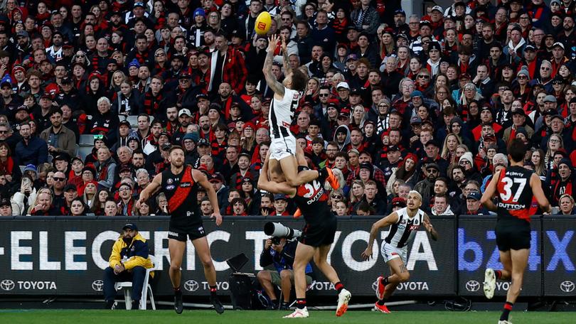 Jamie Elliott  takes a spectacular mark over Ben McKay.