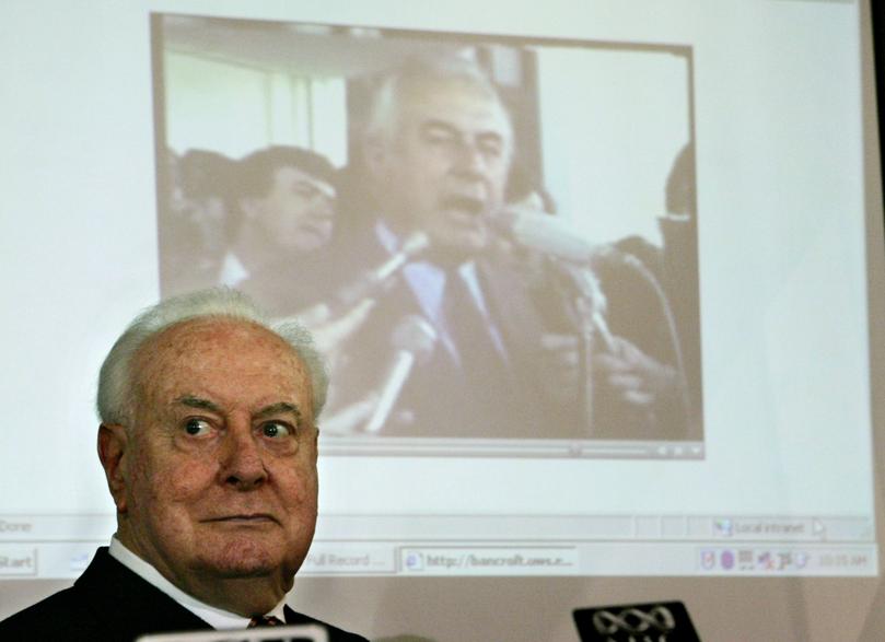 FILE - In this Nov. 7, 2005 file photo, former Australian Prime Minister Gough Whitlam sits as a film clip of one of his speeches plays behind him during a lunch in Sydney, Australia. Whitlam, a controversial social reformer whose grip on power was cut short by a bitter constitutional crisis, died on Tuesday, Oct. 21, 2014, his children said. He was 98. (AP Photo/Mark Baker, File)