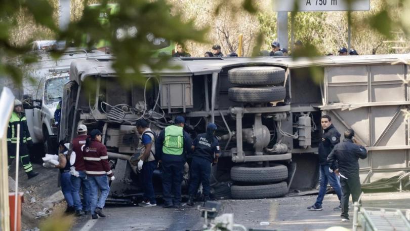 At least 18 people have been killed and dozens more injured after a bus tipped over in Mexico. (EPA PHOTO)