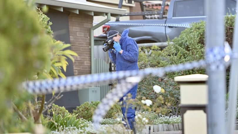 Police at the home of the allegedly murdered woman.