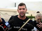 Rabbitohs head coach Jason Demetriou is surrounded by media as he leaves Rabbitohs headquarters on Tuesday.