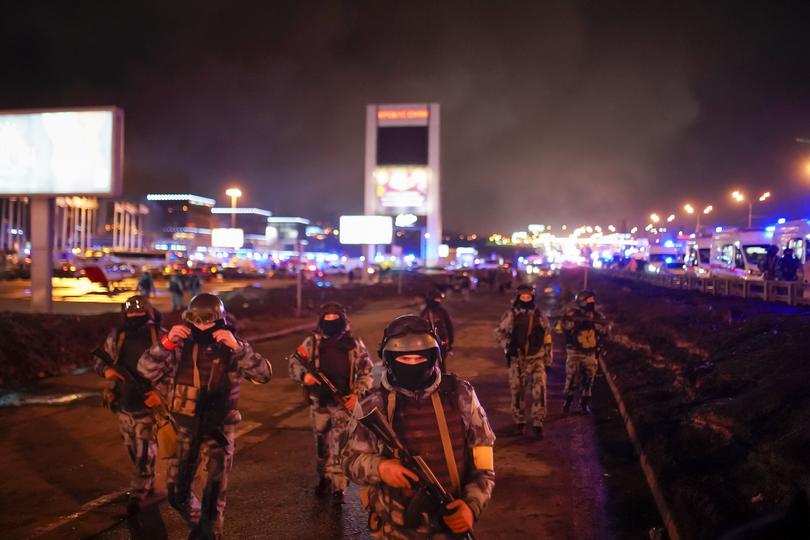 Russian Rosguardia (National Guard) servicemen secure an area at the Crocus City Hall on the western edge of Moscow, Russia, on Saturday, March 23, 2024. Several gunmen have burst into a big concert hall in Moscow and fired automatic weapons at the crowd, injuring an unspecified number of people and setting a massive blaze in an apparent terror attack days after President Vladimir Putin cemented his grip on the country in a highly orchestrated electoral landslide. (Alexander Avilov/Moscow News Agency via AP)