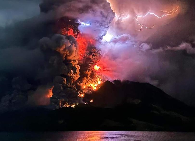 This handout photograph taken and released by the Center for Volcanology and Geological Hazard Mitigation on April 17, 2024, shows Mount Ruang spewing hot lava and smoke as seen from Sitaro, North Sulawesi.