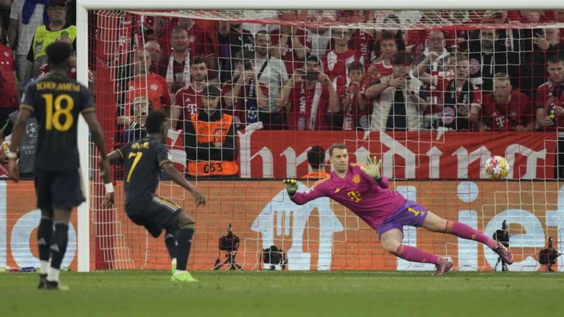 Real Madrid's Vinicius Junior (second left) scores from the penalty spot against Bayern Munich. (AP PHOTO)