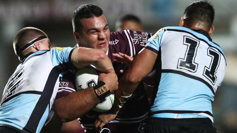 Former Manly player Lloyd Perrett (centre) is threatening to take the club to the Supreme Court. (Brendon Thorne/AAP PHOTOS)