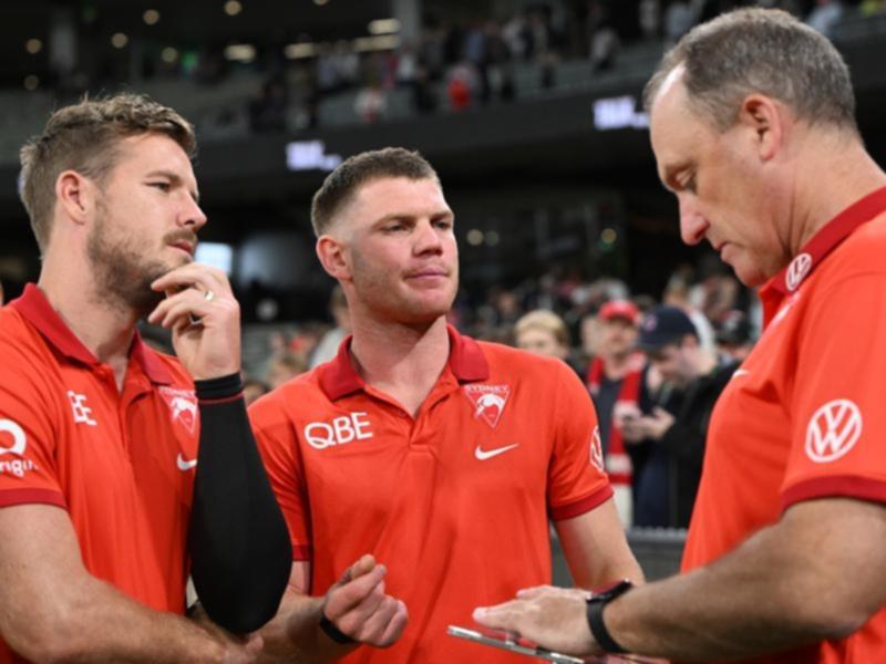 John Longmire (right) chats with Luke Parker (left) and Taylor Adams.