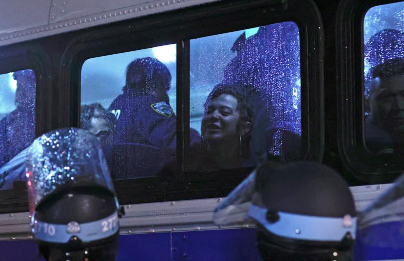 NYPD officers transport arrested students in a bus as they evict a building that had been barricaded by pro-Palestinian student protesters at Columbia University