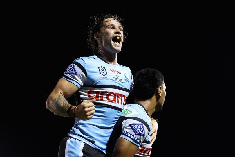 SYDNEY, AUSTRALIA - MARCH 31: Ronaldo Mulitalo of the Sharks celebrates scoring a try with Nicho Hynes of the Sharks during the round four NRL match between Cronulla Sharks and Canberra Raiders at PointsBet Stadium, on March 31, 2024, in Sydney, Australia. (Photo by Cameron Spencer/Getty Images)