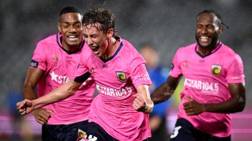 Jacob Farrell (c) celebrates after scoring the Mariners' opening goal against Adelaide United. 