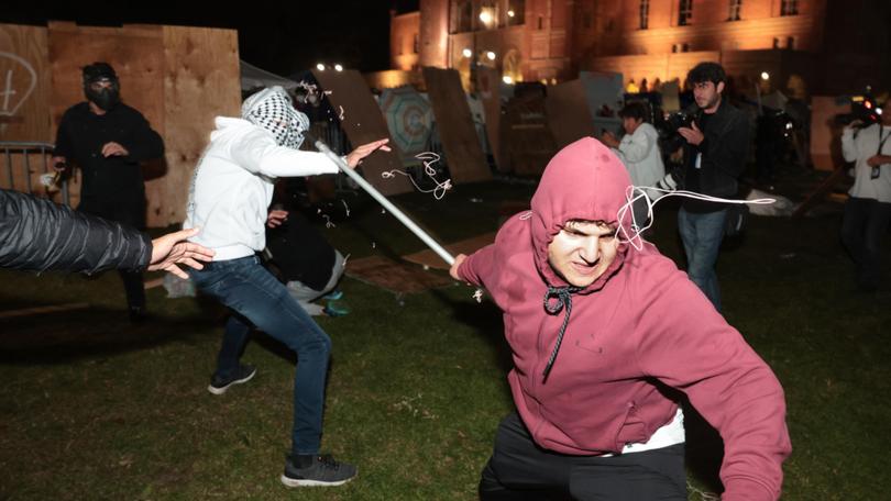 A Pro-Palestinian protester clashes with a pro-Israeli supporter at the UCLA encampment.