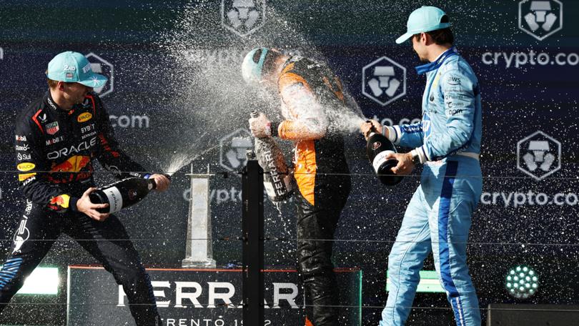 Race winner Lando Norris is sprayed with champagne by of Great Britain Max Verstappen and Charles Leclerc.