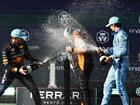 Race winner Lando Norris is sprayed with champagne by of Great Britain Max Verstappen and Charles Leclerc.