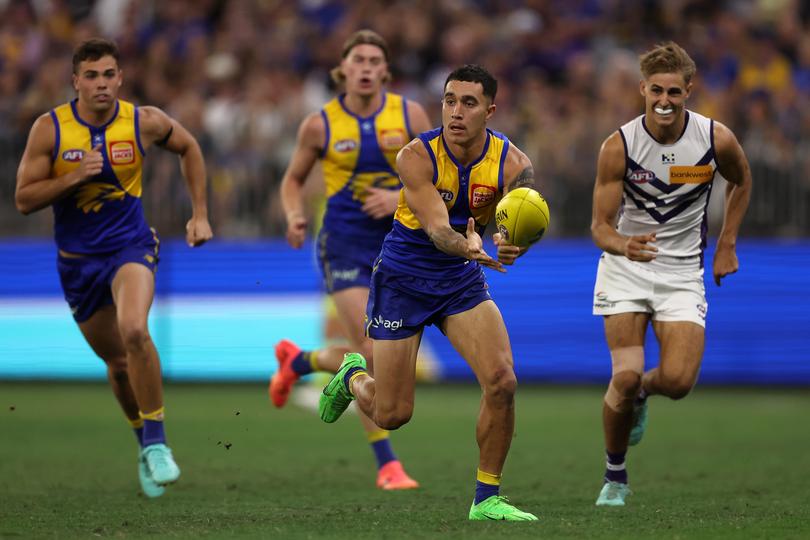 Tyler Brockman of the Eagles handballs during the round six AFL match between West Coast Eagles and Fremantle Dockers at Optus Stadium.