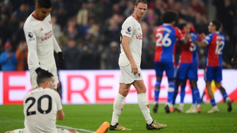 Jonny Evans of Manchester United looks dejected as he looks back towards Casemiro and Diogo Dalot after Tyrick Mitchell of Crystal Palace (not pictured) scored his team's third goal.