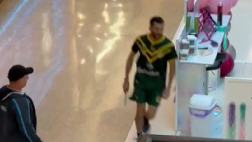 Supplied Editorial A bystander armed with a bollard tries to stop the armed man on an escalator at Westfield Bondi. Picture : 9 News