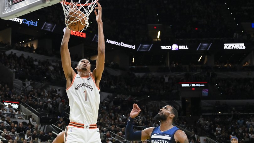 San Antonio Spurs' Victor Wembanyama (1) dunks against Minnesota Timberwolves' Mike Conley (10) during the second half of an NBA basketball in-season tournament game Friday, Nov. 10, 2023, in San Antonio. (AP Photo/Darren Abate)