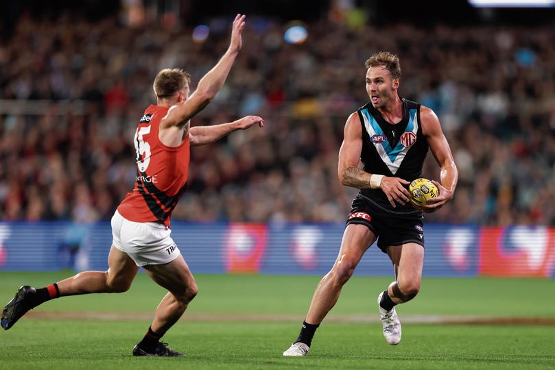 Jeremy Finlayson of the Power is tackled by Jayden Laverde of the Bombers during the AFL Round 4 match between the Port Adelaide Power and the Essendon Bombers at Adelaide Oval in Adelaide, Friday, April 5, 2024. (AAP Image/Matt Turner) NO ARCHIVING, EDITORIAL USE ONLY