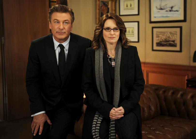 In this 2011 image released by NBC, Alec Baldwin portrays Jack Donaghy, left, and Tina Fey portrays Liz Lemon in the NBC comedy series, "30 Rock." NBC says “30 Rock” will be returning next season for a final, abbreviated run. (AP Photo/NBC, Ali Goldstein)