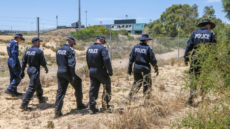 Police search bush outside the perimeter fence of the Perth Motorplex at Kwinana, following the shooting of Rebels bikie Nick Martin.