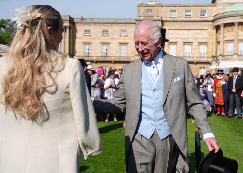 King Charles speaks to guests attending the Royal Garden Party at Buckingham Palace on May 8, 2024 in London, England. 