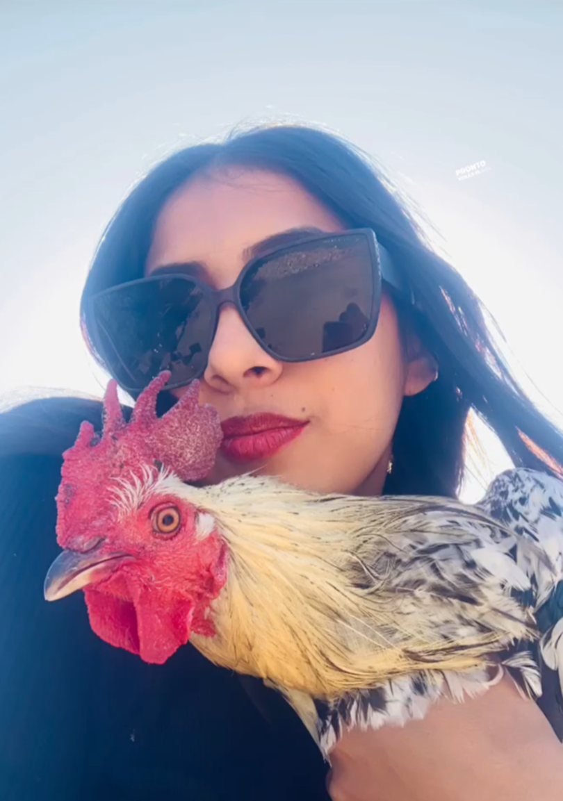 Ari Gisel Garcia Cota with a rooster.