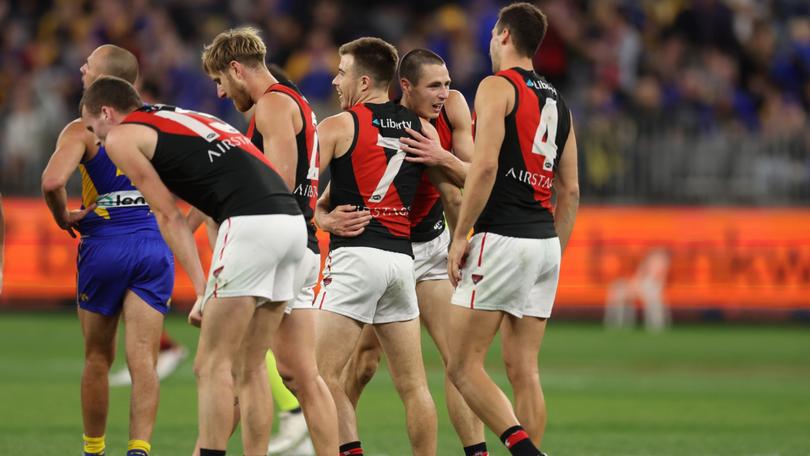 iPERTH, AUSTRALIA - MAY 04: Zach Merrett of the Bombers celebrates with teammates after the win during the 2024 AFL Round 08 match between the West Coast Eagles and the Essendon Bombers at Optus Stadium on May 04, 2024 in Perth, Australia. (Photo by Will Russell/AFL Photos via Getty Images)