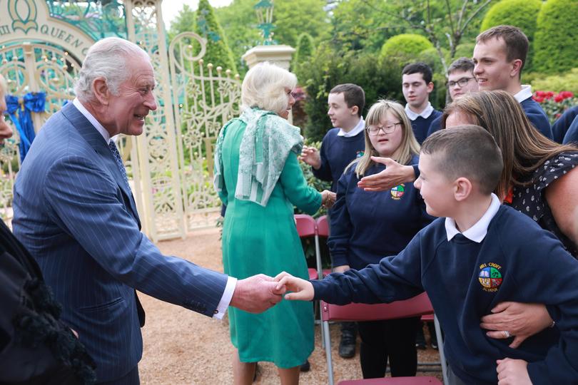 King Charles III and Queen Camilla greet school children during a visit to open the new Coronation Garden in Northern Ireland shortly after his coronation.