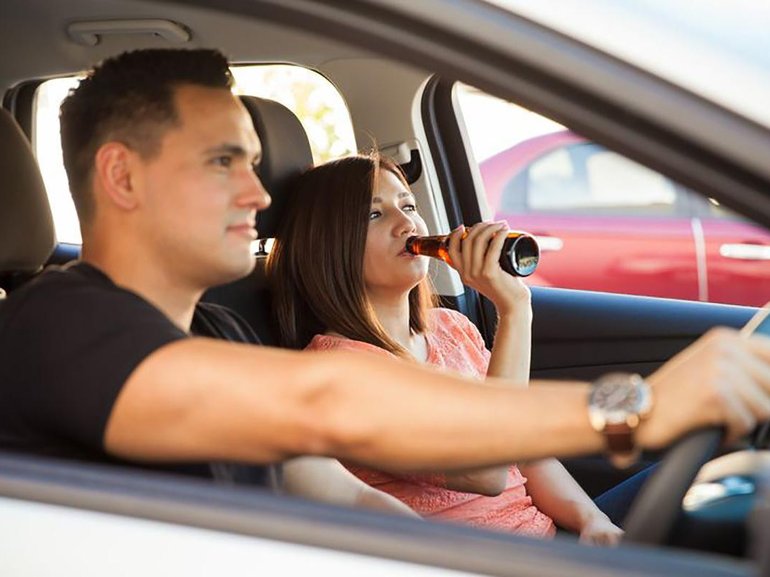 Find out if a driver can get in trouble for passengers consuming booze.