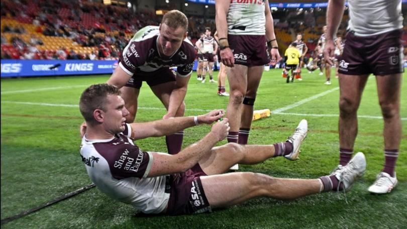 Manly fullback Tom Trbojevic in pain after straining a hamstring in the 30-24 loss to the Dolphins. (Dave Hunt/AAP PHOTOS)