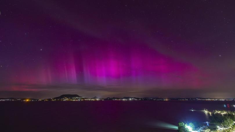 A severe geomagnetic storm lights up the night sky over the Lake Balaton, Hungary. (AP PHOTO)