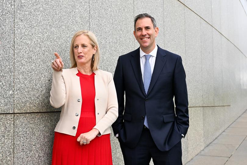 Australian Treasurer Jim Chalmers and Australian Finance Minister Katy Gallagher pose for photographs on the roof of Parliament House in Canberra, Wednesday, May 8, 2024. (AAP Image/Lukas Coch) NO ARCHIVING