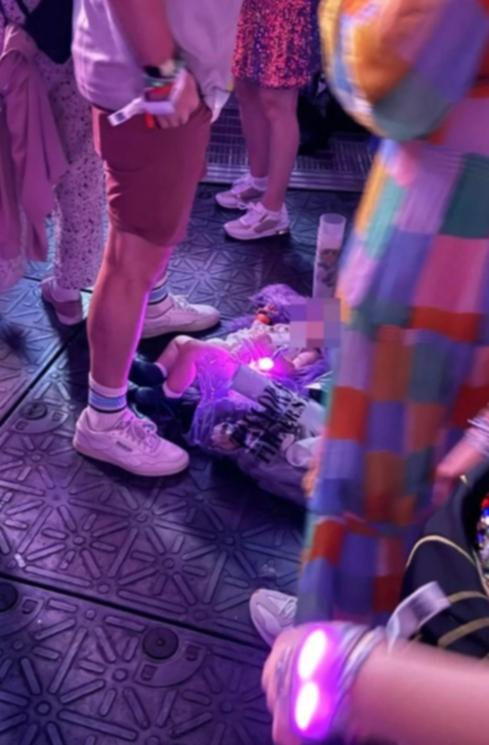 An X user has shared an image of a baby sleeping on a coat on the floor of a Taylor Swift concert.
